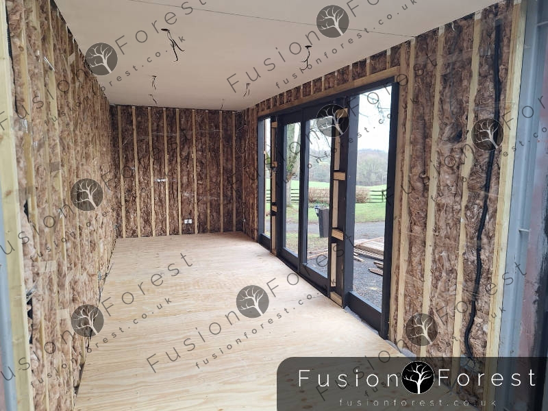 Insulation being fitted in shipping container - Ashford